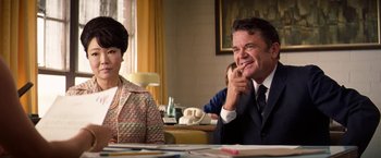 Movie still from “Licorice Pizza” (2021), directed by Paul Thomas Anderson – A man and a woman sitting at a dinner table; Medium shot, Over the shoulder angle