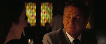 Movie still from “Licorice Pizza” (2021), directed by Paul Thomas Anderson – A person wearing a suit and tie; Close Up shot, Over the shoulder angle