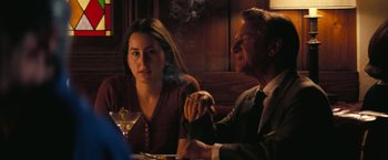 Movie still from “Licorice Pizza” (2021), directed by Paul Thomas Anderson – A man and a woman sitting at a dinner table; Medium shot, Over the shoulder angle