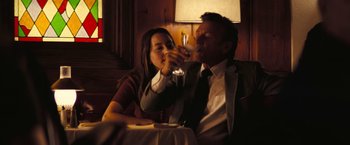 Movie still from “Licorice Pizza” (2021), directed by Paul Thomas Anderson – A man and a woman sitting at a table drinking wine; Medium shot, Over the shoulder angle