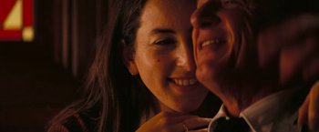 Movie still from “Licorice Pizza” (2021), directed by Paul Thomas Anderson – A woman smiling at a man; Close Up shot, High angle