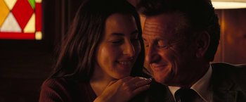 Movie still from “Licorice Pizza” (2021), directed by Paul Thomas Anderson – A man and a woman smiling at each other; Close Up shot, Over the shoulder angle