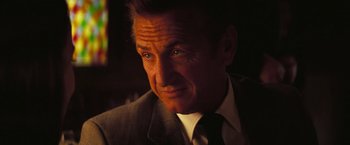 Movie still from “Licorice Pizza” (2021), directed by Paul Thomas Anderson – A person wearing a suit and tie; Close Up shot, Low angle