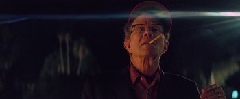 Movie still from “Licorice Pizza” (2021), directed by Paul Thomas Anderson – An older man is smoking a cigarette in the dark; Close Up shot, Low angle