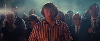 Movie still from “Licorice Pizza” (2021), directed by Paul Thomas Anderson – A group of people standing in a room; Medium shot, Low angle