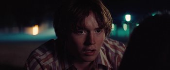 Movie still from “Licorice Pizza” (2021), directed by Paul Thomas Anderson – A person wearing a striped shirt; Close Up shot, Over the shoulder angle