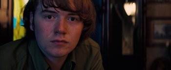 Movie still from “Licorice Pizza” (2021), directed by Paul Thomas Anderson – A person with long brown hair; Close Up shot, Low angle