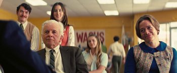 Movie still from “Licorice Pizza” (2021), directed by Paul Thomas Anderson – A group of people standing in a room; Medium shot, Over the shoulder angle