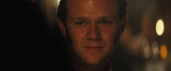 Movie still from “Licorice Pizza” (2021), directed by Paul Thomas Anderson – A man's face in the dark; Close Up shot, Over the shoulder angle