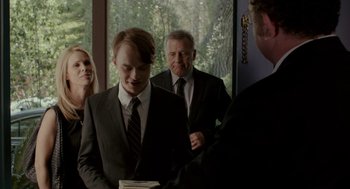 Movie still from “Life After Beth” (2014), directed by Jeff Baena – A group of people in suits standing next to each other; Medium shot, Over the shoulder angle