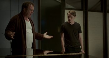 Movie still from “Life After Beth” (2014), directed by Jeff Baena – Two men standing next to each other in front of a mirror; Medium shot, Over the shoulder angle