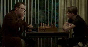 Movie still from “Life After Beth” (2014), directed by Jeff Baena – Two people sitting at a table playing a game of chess; Medium shot, Over the shoulder angle