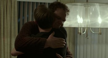 Movie still from “Life After Beth” (2014), directed by Jeff Baena – A man and a woman hugging in a living room; Medium shot, Over the shoulder angle