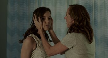 Movie still from “Life After Beth” (2014), directed by Jeff Baena – A woman touching the face of another woman with their hands; Close Up shot, Over the shoulder angle