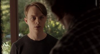 Movie still from “Life After Beth” (2014), directed by Jeff Baena – A young man looking into a mirror while standing next to another man; Close Up shot, Over the shoulder angle