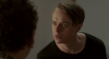 Movie still from “Life After Beth” (2014), directed by Jeff Baena – A man looking into a mirror while wearing a black t - shirt; Close Up shot, Over the shoulder angle