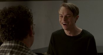 Movie still from “Life After Beth” (2014), directed by Jeff Baena – A young man laughing with another young man in a room; Close Up shot, Over the shoulder angle
