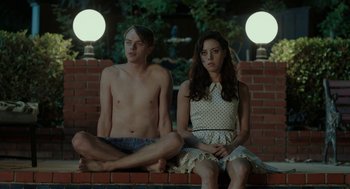 Movie still from “Life After Beth” (2014), directed by Jeff Baena – A man and a woman sitting next to each other; Medium shot, High angle