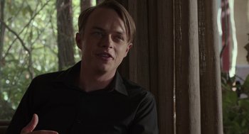 Movie still from “Life After Beth” (2014), directed by Jeff Baena – A man in a black shirt is looking at the camera; Close Up shot, Over the shoulder angle