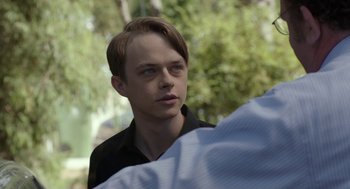 Movie still from “Life After Beth” (2014), directed by Jeff Baena – A young man is standing in front of a camera; Close Up shot, Over the shoulder angle