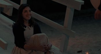 Movie still from “Life After Beth” (2014), directed by Jeff Baena – A woman sitting on the ground next to a railing at night; Medium shot, High angle