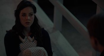 Movie still from “Life After Beth” (2014), directed by Jeff Baena – A woman sitting on steps in the dark; Close Up shot, High angle