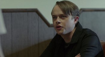 Movie still from “Life After Beth” (2014), directed by Jeff Baena – A young man with short blonde hair wearing a black shirt; Close Up shot, Over the shoulder angle