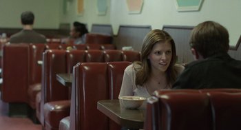 Movie still from “Life After Beth” (2014), directed by Jeff Baena – A woman sitting at a table with a bowl of soup; Medium shot, Over the shoulder angle