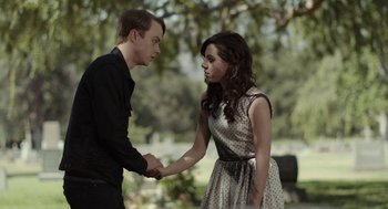 Movie still from “Life After Beth” (2014), directed by Jeff Baena – A man and a woman shaking hands in a park; Medium shot, Over the shoulder angle
