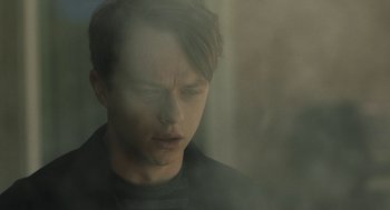 Movie still from “Life After Beth” (2014), directed by Jeff Baena – A young man is looking out of a window; Close Up shot, Low angle