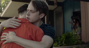 Movie still from “Life After Beth” (2014), directed by Jeff Baena – A young man hugging another young man outside; Close Up shot, Over the shoulder angle