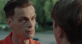 Movie still from “Life After Beth” (2014), directed by Jeff Baena – A young man looking at another young man in the street; Close Up shot, Over the shoulder angle