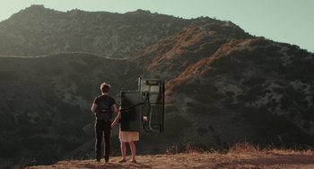Movie still from “Life After Beth” (2014), directed by Jeff Baena – A man and a woman standing on top of a hill; Wide shot, Low angle