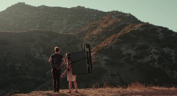 Movie still from “Life After Beth” (2014), directed by Jeff Baena – A man and a woman standing on a hill; Wide shot, Low angle