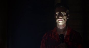 Movie still from “Life After Beth” (2014), directed by Jeff Baena – A man is holding a flashlight in the dark; Close Up shot, Low angle