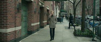 Movie still from “Life Itself” (2018), directed by Dan Fogelman – A woman walking down a sidewalk while talking on a cell phone; Wide shot, Low angle