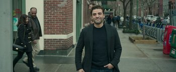Movie still from “Life Itself” (2018), directed by Dan Fogelman – A man standing on the sidewalk in front of a brick building; Medium shot, Over the shoulder angle