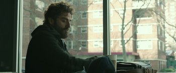 Movie still from “Life Itself” (2018), directed by Dan Fogelman – A man sitting in front of a window holding a coffee cup; Medium shot, Over the shoulder angle