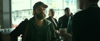 Movie still from “Life Itself” (2018), directed by Dan Fogelman – A man with a beard and a hat is holding a cup of coffee; Close Up shot, Over the shoulder angle