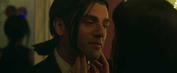 Movie still from “Life Itself” (2018), directed by Dan Fogelman – A man with long hair is putting on a tie; Close Up shot, Over the shoulder angle