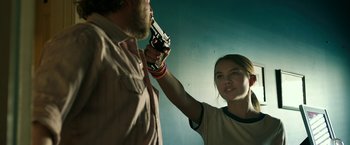 Movie still from “Life Itself” (2018), directed by Dan Fogelman – A man and a woman are holding a gun; Medium shot, Over the shoulder angle