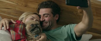 Movie still from “Life Itself” (2018), directed by Dan Fogelman – A man and a woman laying on the ground with a dog; Close Up shot, Over the shoulder angle