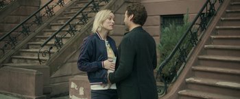 Movie still from “Life Itself” (2018), directed by Dan Fogelman – A man and a woman standing next to each other on steps; Medium shot, Over the shoulder angle