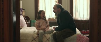 Movie still from “Life Itself” (2018), directed by Dan Fogelman – An older man sitting on a bed talking to a young girl; Medium shot, Over the shoulder angle