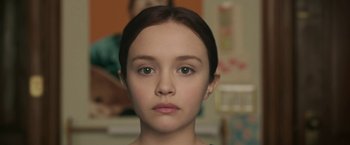 Movie still from “Life Itself” (2018), directed by Dan Fogelman – A young girl is looking directly at the camera; Close Up shot, Low angle