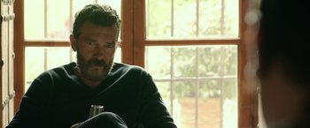 Movie still from “Life Itself” (2018), directed by Dan Fogelman – A man sitting in front of a window holding a beer; Close Up shot, Over the shoulder angle