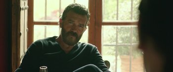 Movie still from “Life Itself” (2018), directed by Dan Fogelman – A man sitting in front of a window with a beard; Close Up shot, Over the shoulder angle