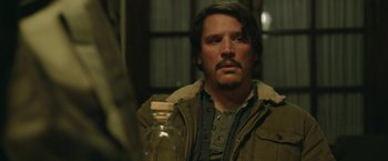 Movie still from “Life Itself” (2018), directed by Dan Fogelman – A man with a bottle in his hand looking at the camera; Close Up shot, Over the shoulder angle