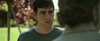 Movie still from “Life Itself” (2018), directed by Dan Fogelman – A young man looking at a woman in a green shirt; Close Up shot, Over the shoulder angle