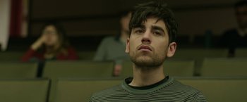 Movie still from “Life Itself” (2018), directed by Dan Fogelman – A man with a beard is standing in front of a group of people; Close Up shot, Low angle